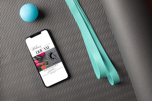 FREE 44-page holistic wellness planner for women in transition digital journal on iPhone on a yoga mat